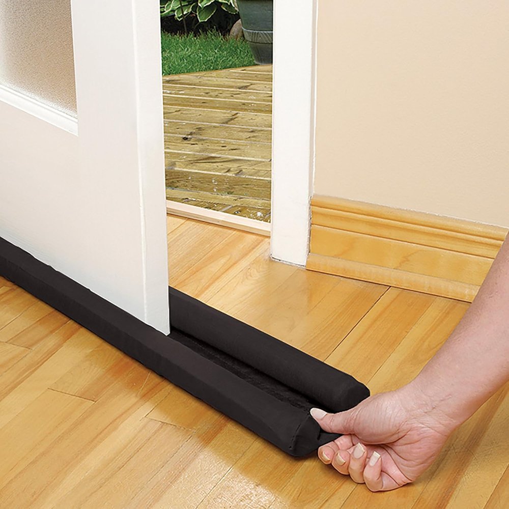 Twin Draft Guard Extreme in black under a white door on a hardwood floor